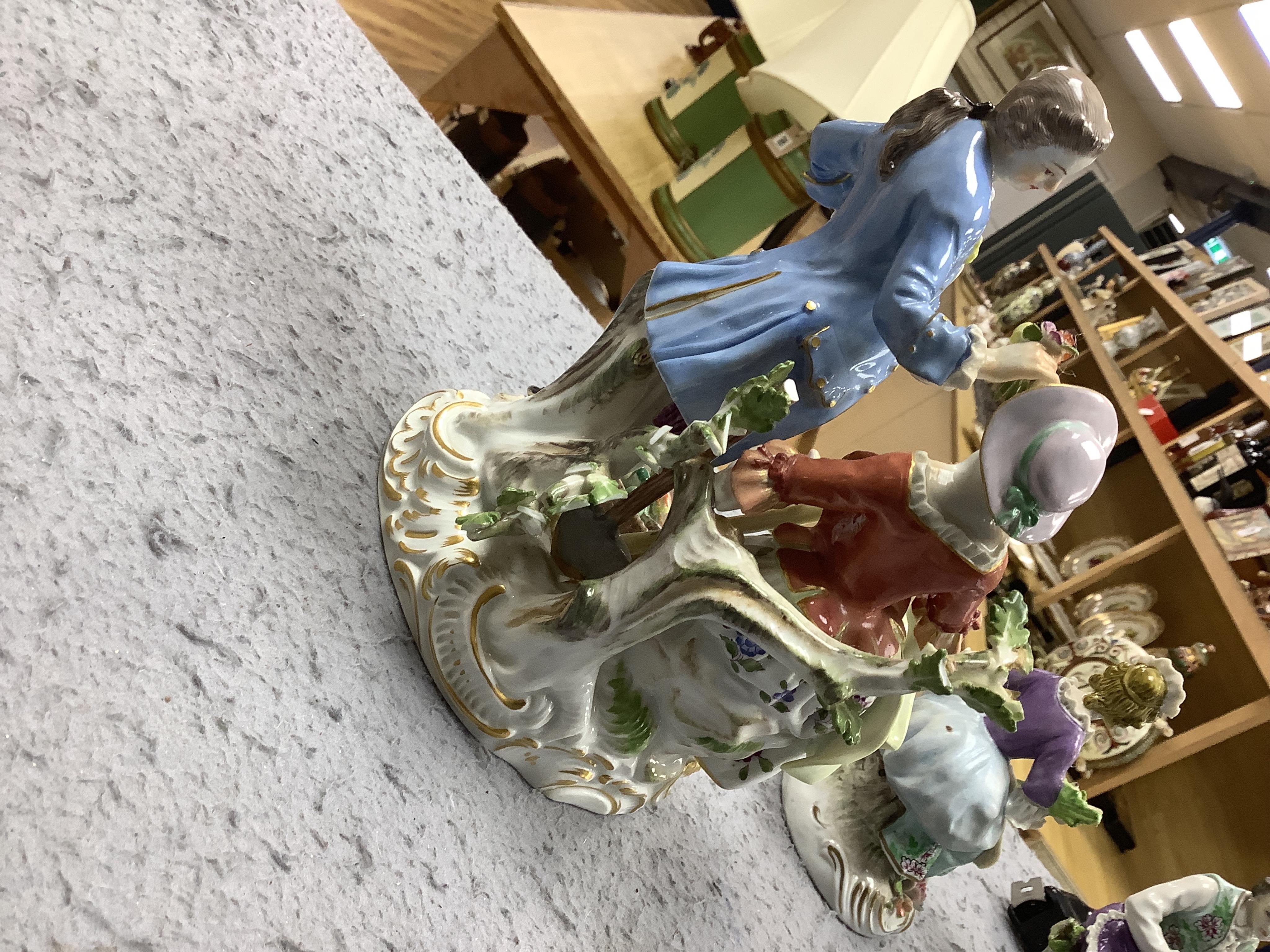 A 20th century Meissen figure group and two other Continental porcelain figures, largest 19cm high. Condition - fair/good